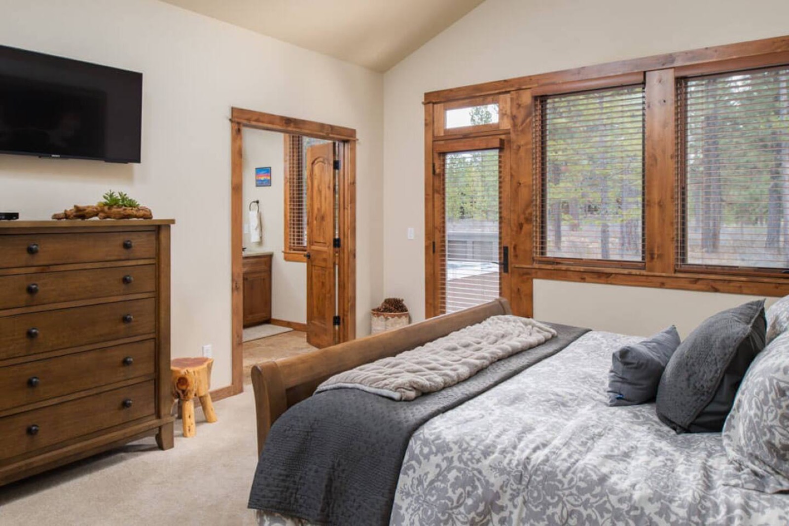 Main-floor bedroom with a king bed and doors to the patio