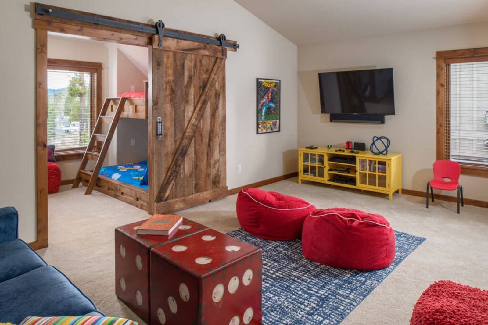 Upstairs loft with bunk beds, a sofa and television