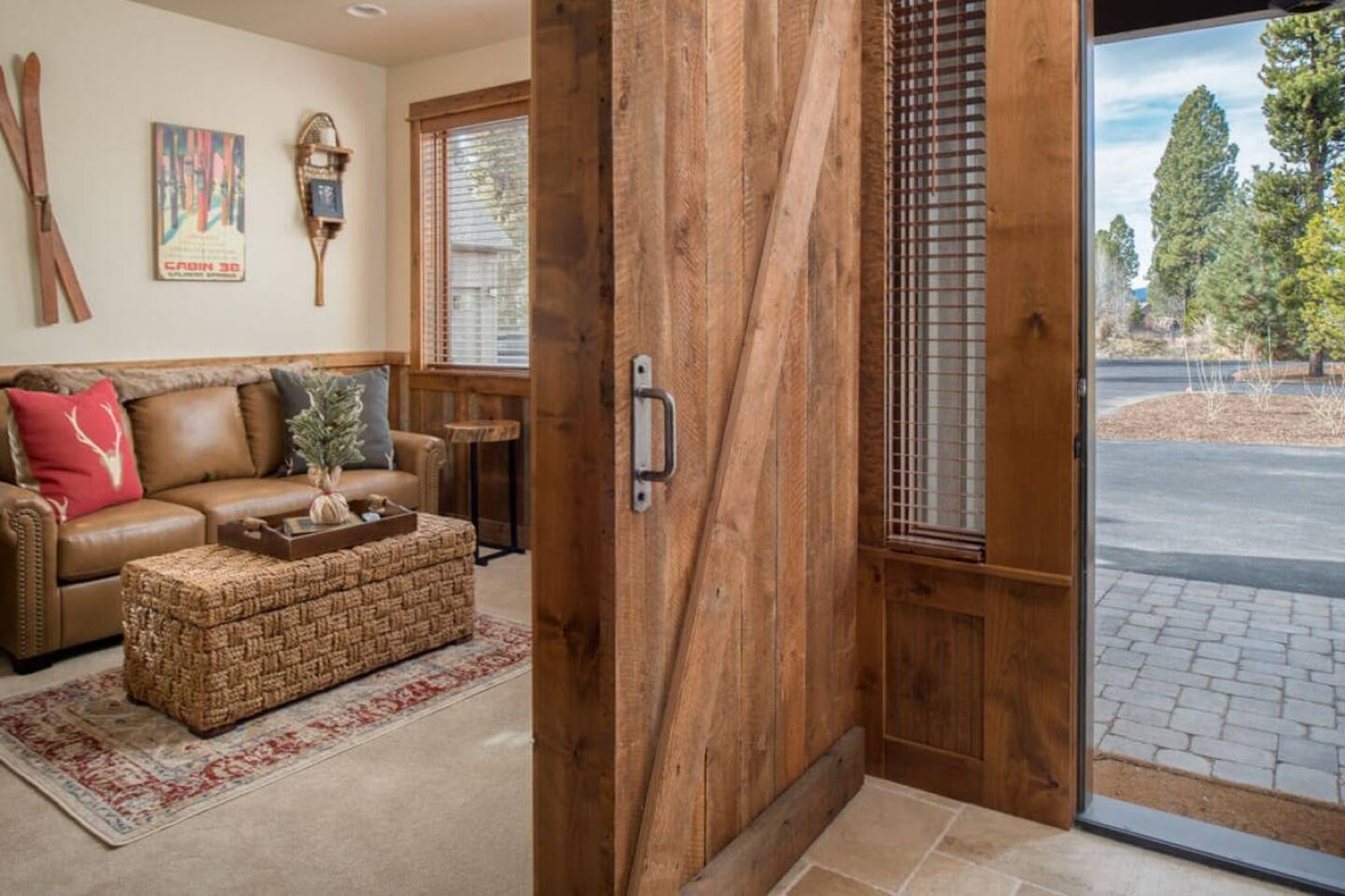 Entry hall and adjacent office with a sliding barn door