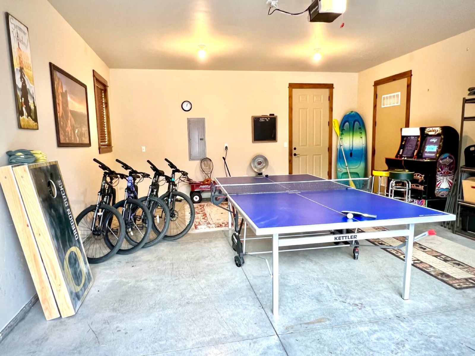 Garage game room with ping pong, arcade games and outdoor equipment