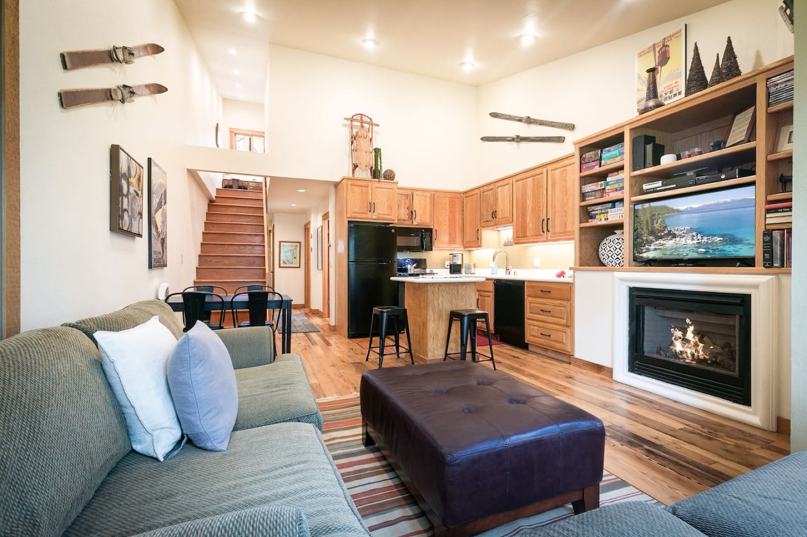 Open-plan living room with sofas, a dining table and a gas fireplace