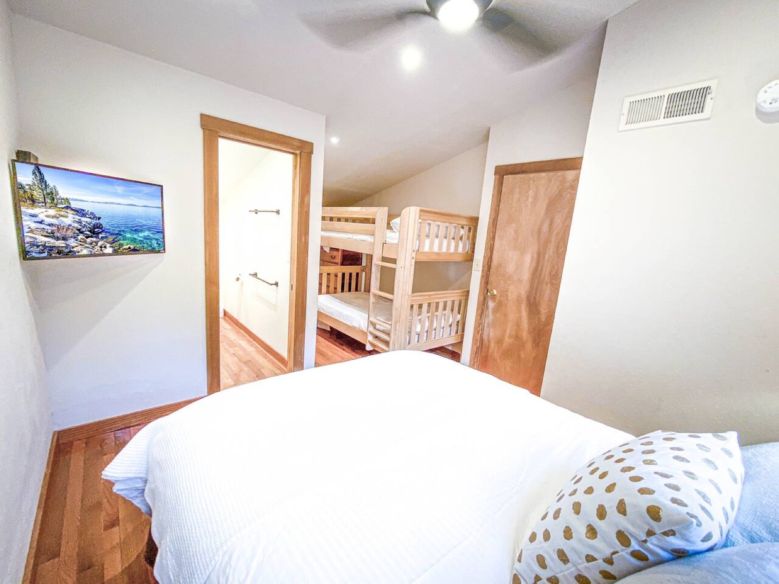 Upstairs bedroom with a queen bed, twin bunk bed and private bathroom